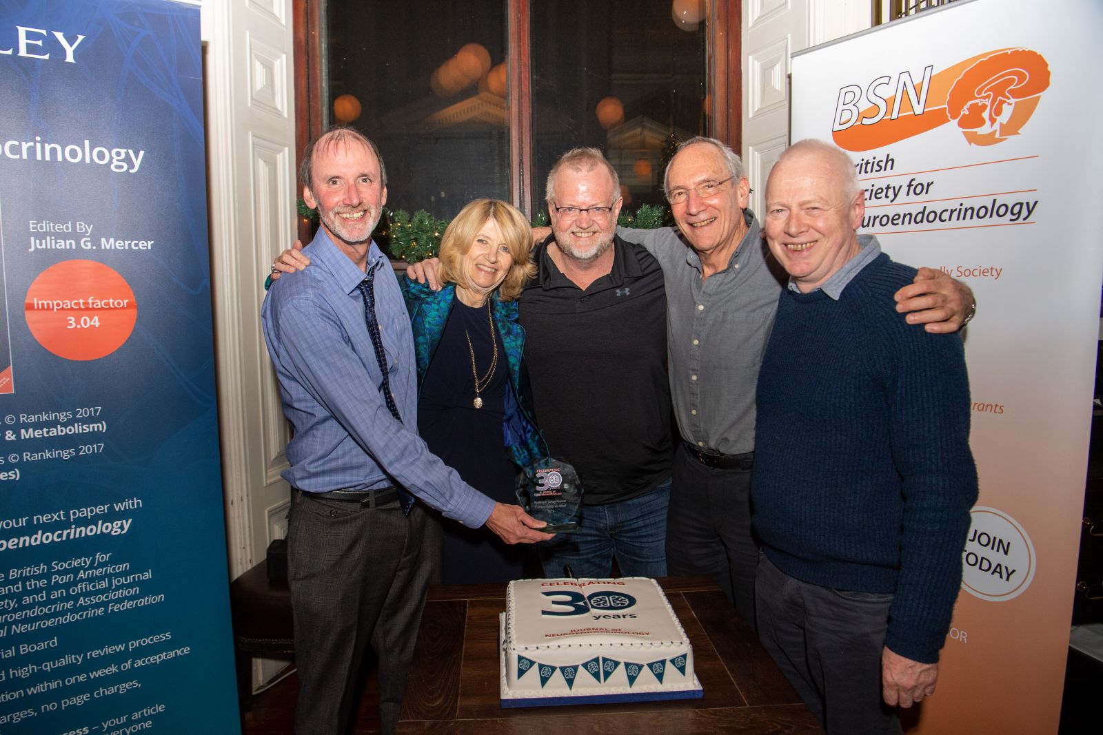 JNE editors cutting the JNE30 celebration cake
